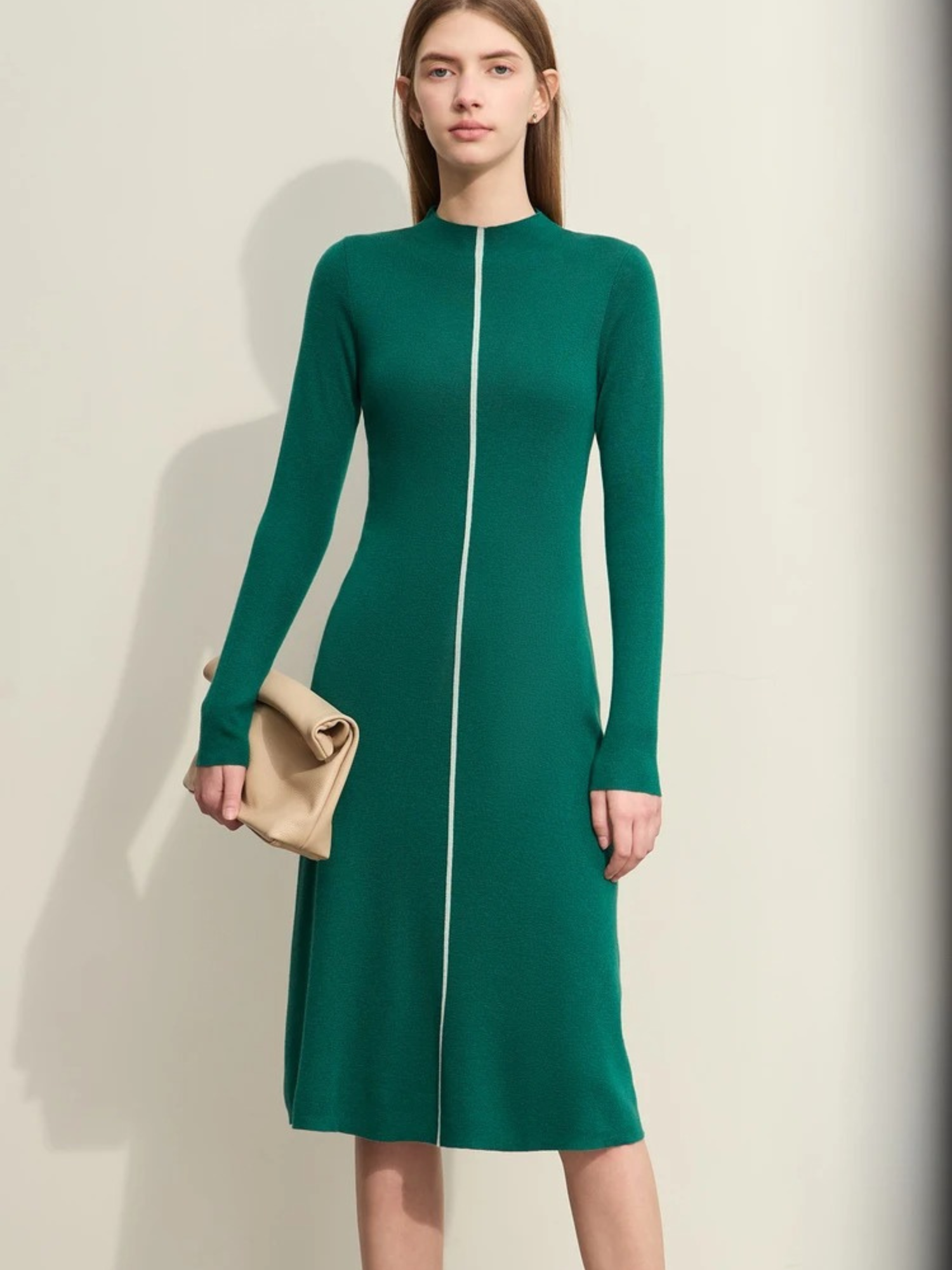 Grünes Strickkleid mit Reißverschluss, Modell frontal stehend.